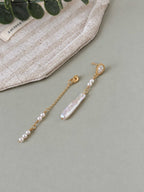 Shift pearl earring components showing the baroque pearl drop, delicate chain and convertible styling details.