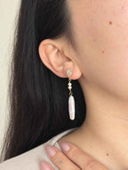 Shift convertible pearl earring worn in its clean single-drop style with a long freshwater baroque pearl.