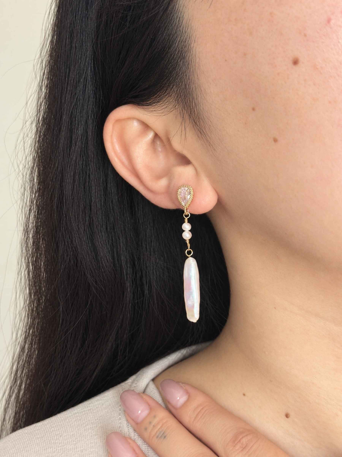 Shift convertible pearl earring worn in its clean single-drop style with a long freshwater baroque pearl.