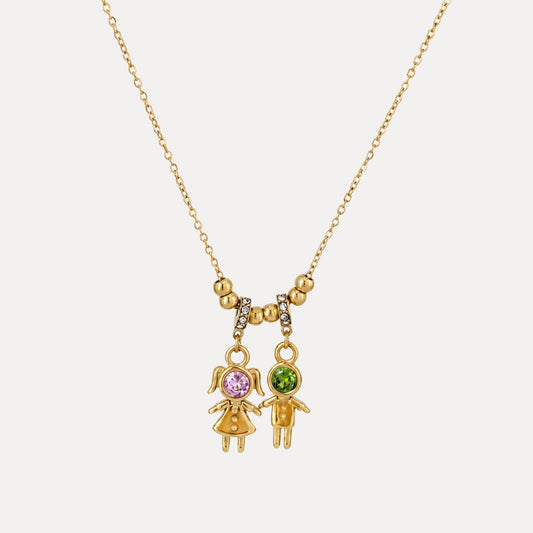 Front view of gold duo charm necklace with pink cubic zirconia girl figure and green cubic zirconia boy figure