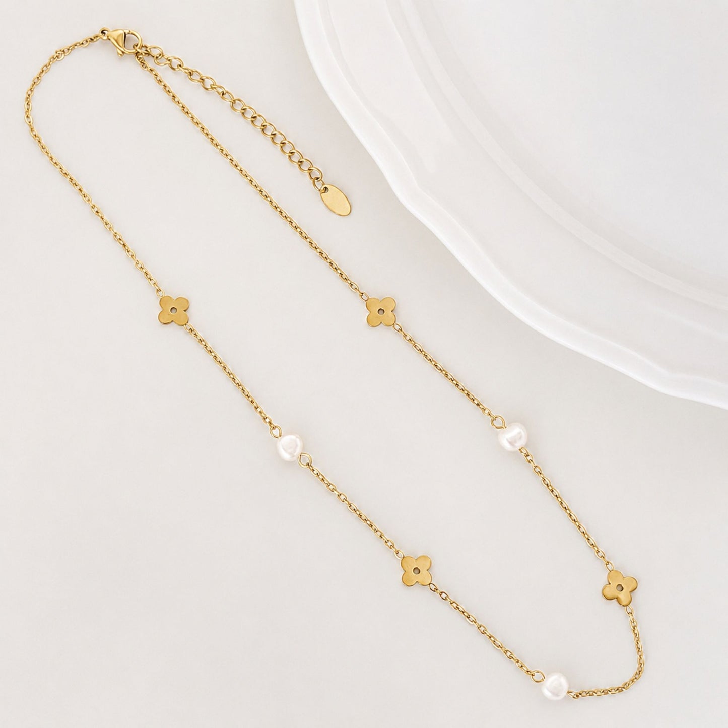 Soft Bloom Pearl Necklace laid flat with freshwater pearls and gold flower details.
