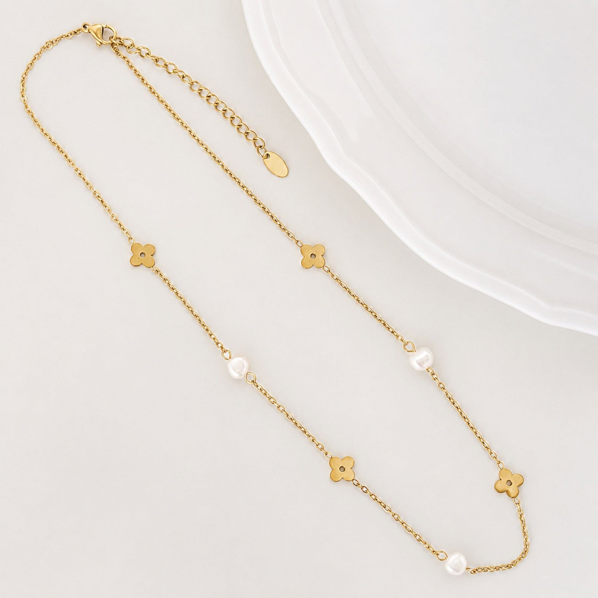 Soft Bloom Pearl Necklace laid flat with freshwater pearls and gold flower details.