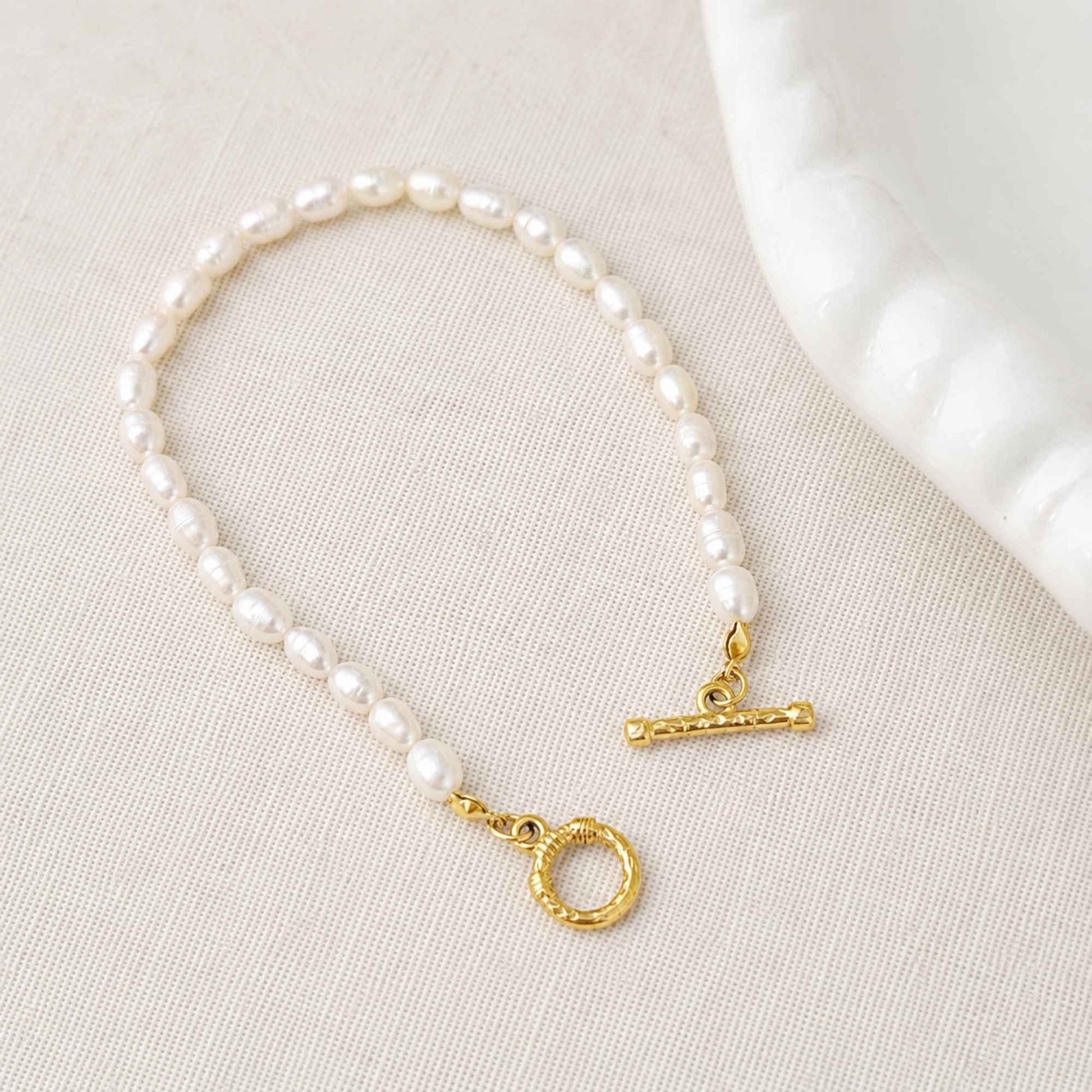 Close-up of freshwater pearls and 18k gold-plated stainless steel toggle clasp.