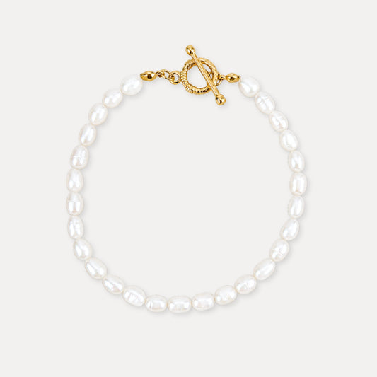 Freshwater pearl bracelet with a gold toggle clasp and soft natural pearl texture.