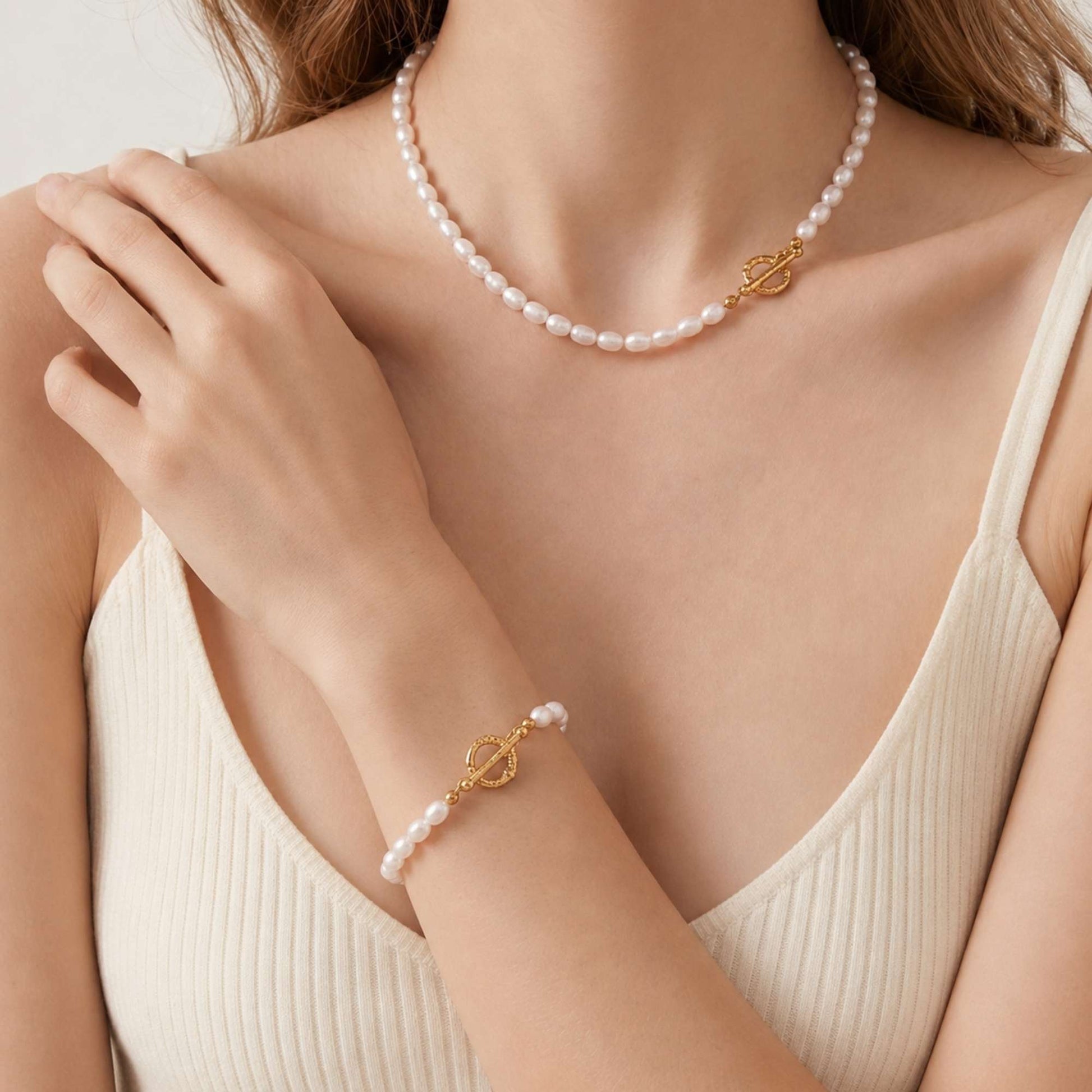 Freshwater pearl bracelet styled with a matching pearl necklace in soft natural light.