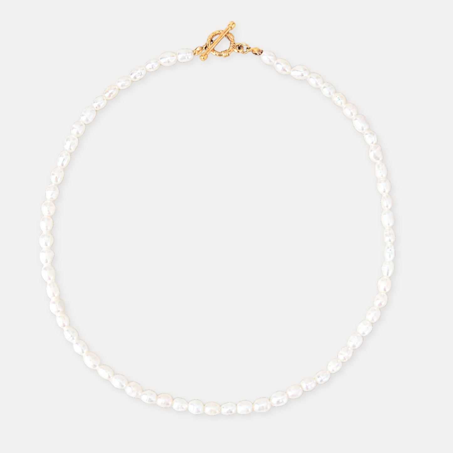 Freshwater pearl necklace with a gold toggle clasp and soft natural pearl texture.