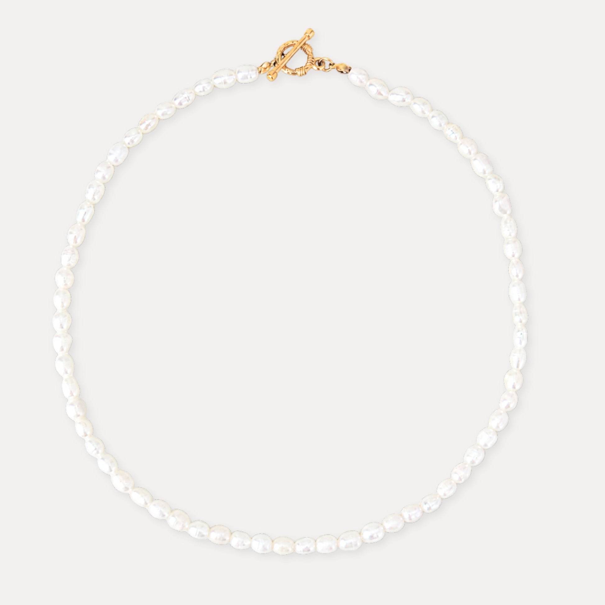 Freshwater pearl necklace with a gold toggle clasp and soft natural pearl texture.