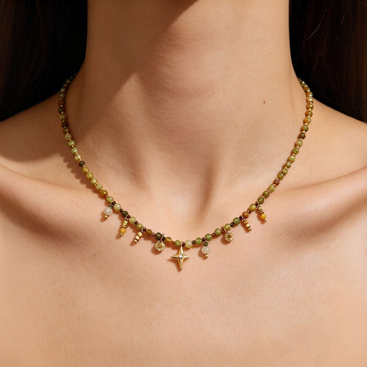 Natural stone charm necklace worn on the collarbone in warm sunlight