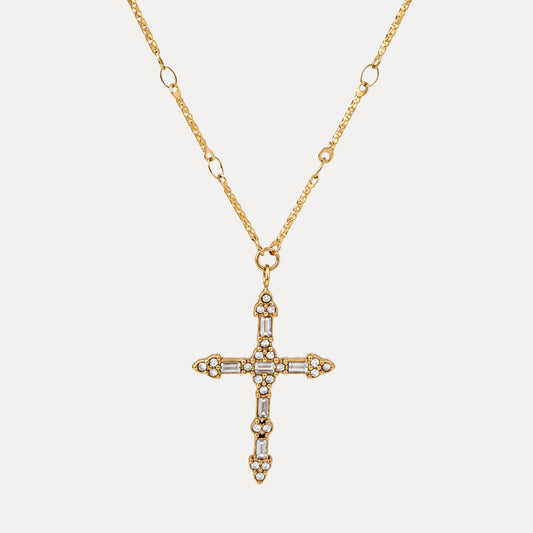 Steadfast Cross Necklace with rectangular and round clear stone details on a gold cross pendant