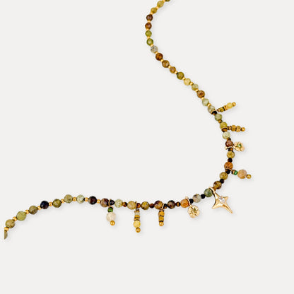 Close-up of the Steadfast beaded necklace featuring Tsavorite, Tiger’s Eye, and small gold-tone details.