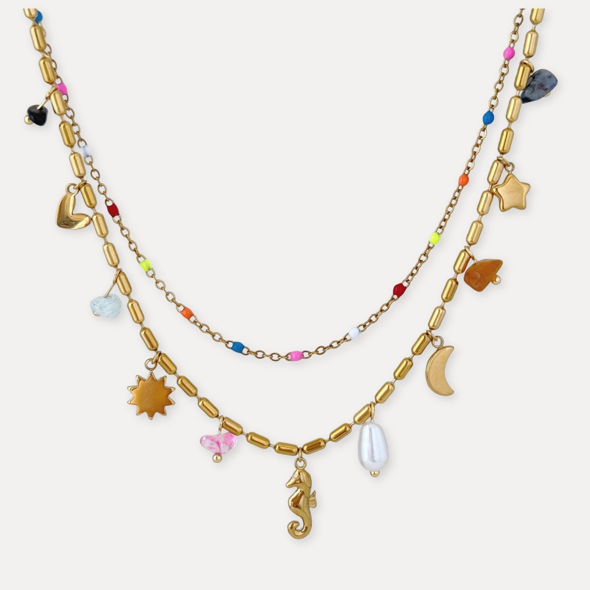 Gold layered charm necklace with colorful bead details, sea-inspired pendants, and 18k gold-plated stainless steel finish.