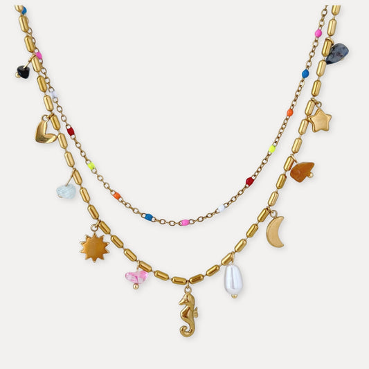 Gold layered charm necklace with colorful bead details, sea-inspired pendants, and 18k gold-plated stainless steel finish.