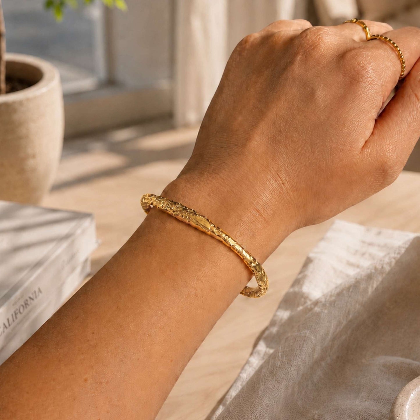 Waterproof gold stainless steel cuff bracelet styled with everyday rings