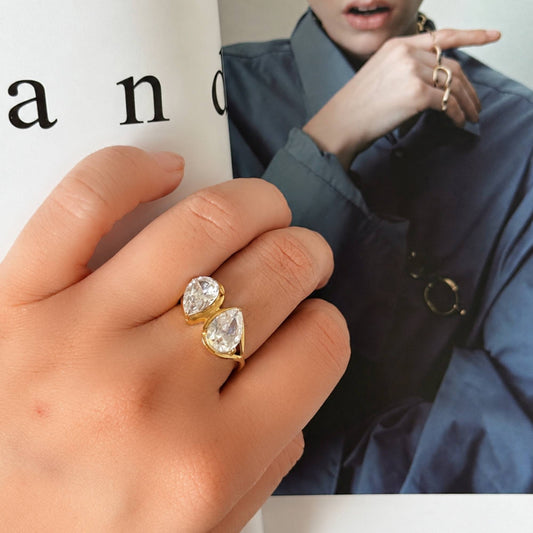 Gold Twin Drop CZ Ring with two clear pear-shaped stones photographed in natural light